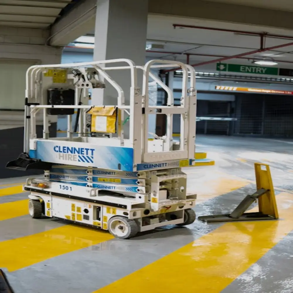 A scissor lift machine in a parking garage